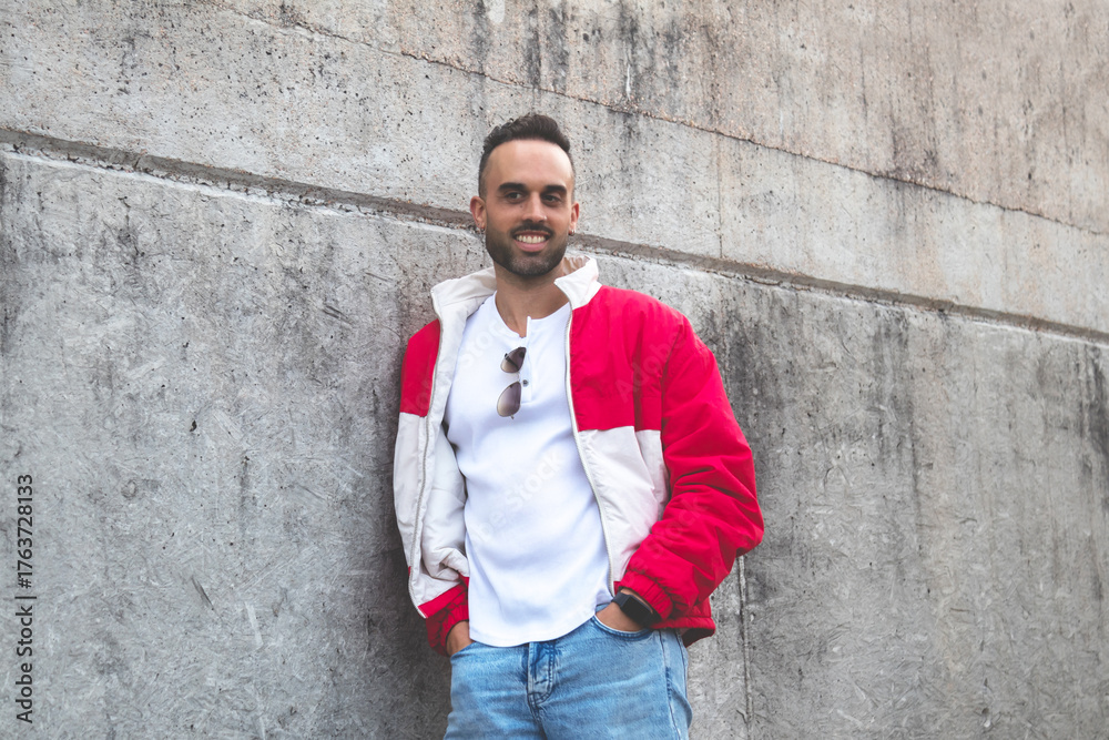 Obraz premium handsome casual man with hands in pockets posing on the street