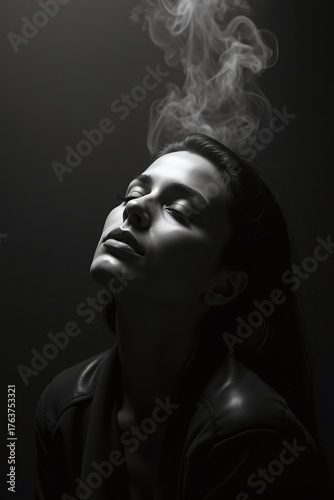 Elegant black and white portrait of woman with rising smoke.