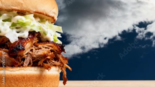 Delicious Pulled Pork Sandwich With Creamy Coleslaw Topped With BBQ Sauce Against A Dark Blue Cloudy Sky Background On A Wooden Surface