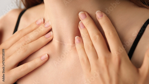 Wallpaper Mural Close-up of an unrecognizable woman touching her neck. Endocrine health prevention, treatment. Diseases of the thyroid gland. Cancer screening. Endocrinology. Medical concept, Healthcare, Self-care. Torontodigital.ca