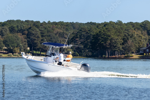 Photography Fishermen on center console fishing boat enjoy summer day on the lake