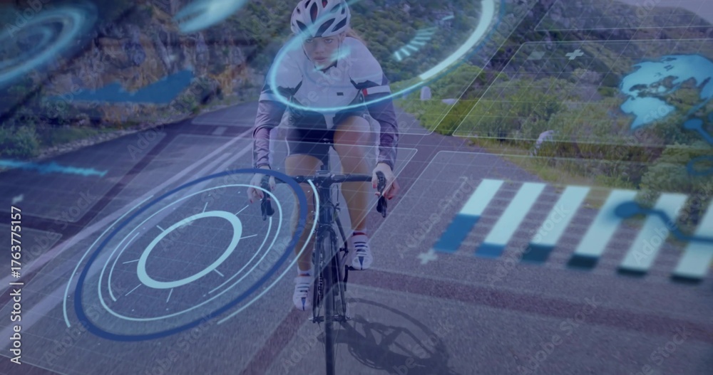 Fototapeta premium Riding female cyclist pedaling road bike wearing helmet along mountain road with blue HUD overlays