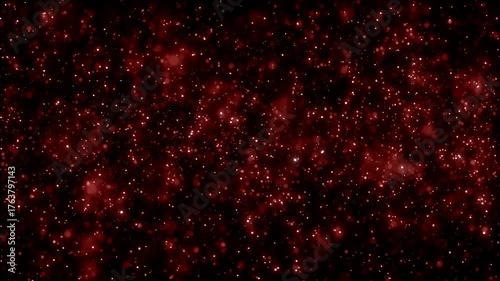 Vibrant abstract red background of glowing dust and light particles resembling a cosmic nebula or fiery star field