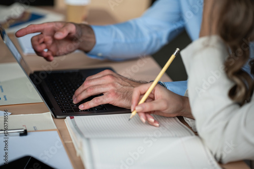 Valokuva Business colleagues collaborating on laptop and taking notes