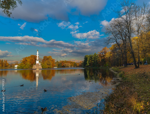 Autumn landscape with the Chesme Column, trees reflected in the water. Catherine Park, Pushkin, St. Petersburg, Russia.