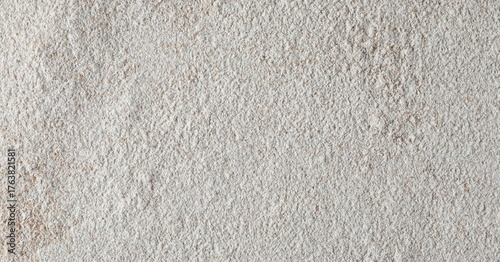 Pile of integral barley flour background and texture, top view