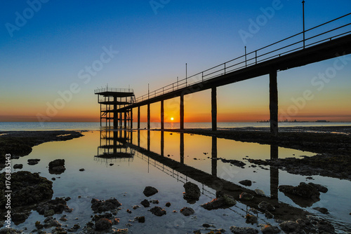 Beautiful Fishing bridge during the early sunrise at Arabian sea near to Kuwait city