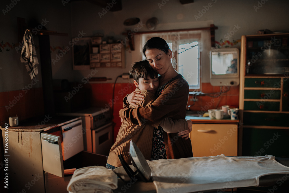 Naklejka premium Single mother hugging her child during hard times.