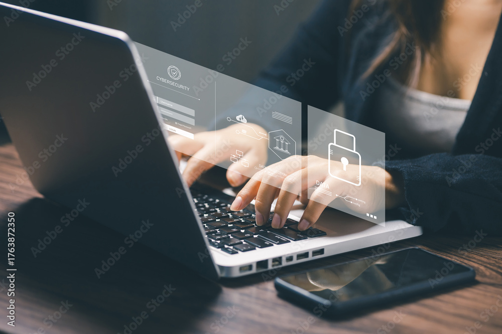 © saranyoo - A woman typing on a laptop with floating cybersecurity login interface, representing data protection, system security, user authentication, and technology privacy concept. © saranyoo - A woman typing on a laptop with floating cybersecurity login interface, representing data protection, system security, user authentication, and technology privacy concept.