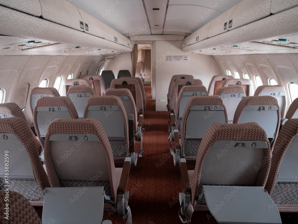 Fototapeta premium airplane interior scene, symmetrical airplane cabin layout with ambiance and seating, interior of airplane showing economy class with symmetrical seating arrangement and lighting ambiance