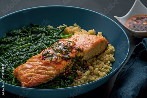 Baked Salmon Fillet on Bed of Quinoa and Wilted Spinach.