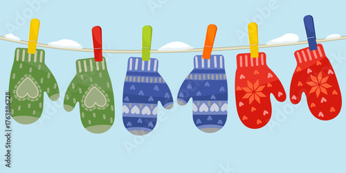 Set of mittens hanging on the rope.