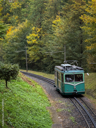 Vintage Green Tram Passing Through Autumn Forest