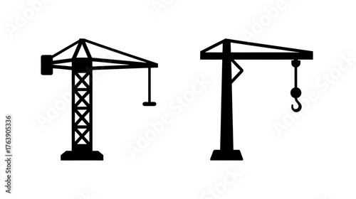 Two silhouette construction tower cranes ready for building site work and heavy lifting operations