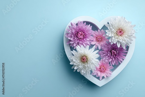 Colorful Pink Flowers Arranged in Heart Shape in a Blue Box on a Light Backgr...