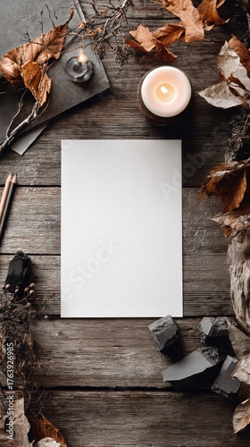 Blank Canvas Surrounded by Autumn Leaves and Candle on Rustic Wooden Table fo...