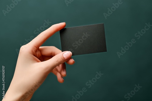 Holding a Blank Business Card in One Hand Against a Dark Background Showcasin...