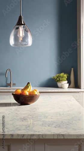 Modern Kitchen With Marble Countertop, Fruit Bowl, and Fresh Flowers in Brigh...