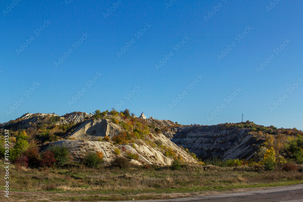 Fototapeta premium An autumn landscape with a road in northern Moldova, through wooded and mountainous terrain.