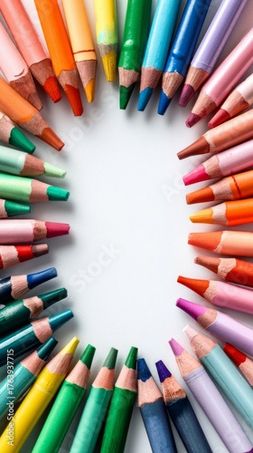 Colorful Arrangement of Pencils Creates Circle on White Paper Background