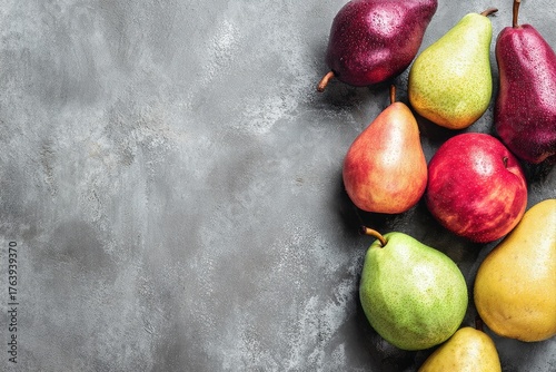 Fresh and Colorful Pears Arranged on a Gray Surface Ready for a Healthy Snack...