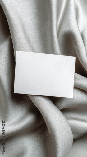 Blank Business Card Resting on Elegant Silver Fabric