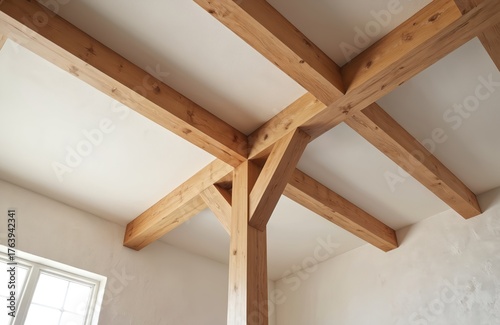 Detailed close-up of natural wood timber beams forming roof structure, indoor construction detail. Visible grain, rustic texture on oak planks, supporting interior ceiling. Minimalist design focuses