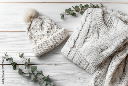Cozy Knit Hat and Sweater With Greenery on a Wooden Surface in a Warm Setting