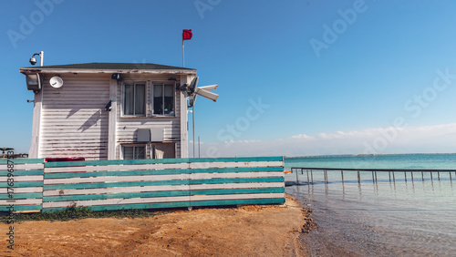 A wooden lifeguard station on the shore of a warm sea