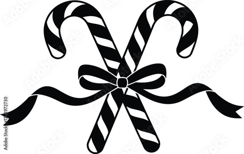 Two crossed candy canes decorated with a festive bow and flowing ribbons
