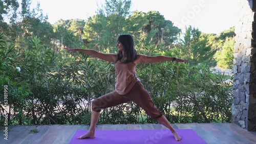 Woman practicing yoga pose on an outdoor terrace