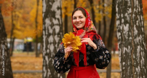 Young beautiful woman in a headscarf in an autumn park