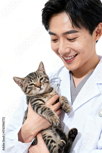Smiling veterinarian holding cute cat