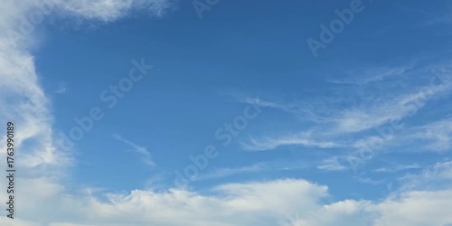 Cloudscape, Timelapse of Gentle white clouds flowing across bright blue sky, for background	