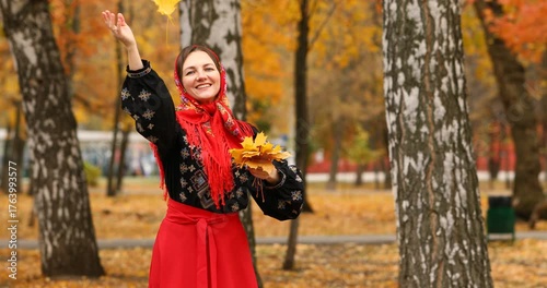 Young beautiful woman in a headscarf in an autumn park