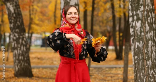Young beautiful woman in a headscarf in an autumn park