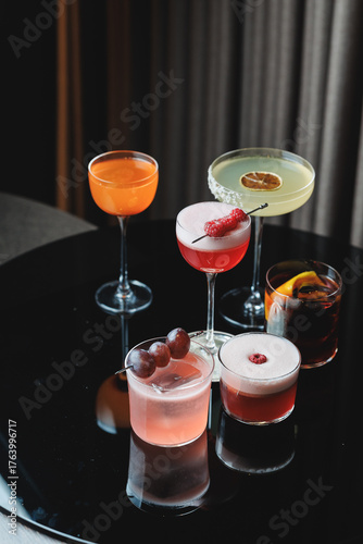 Assortment of Vibrant Cocktails on a Reflective Dark Surface