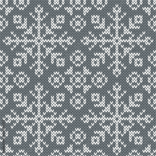 Snowflakes jacquard seamless pattern. Grey and white knitted background. Northern winter style. Vector illustration.