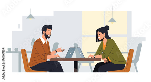 Discussion And Collaboration Between Two Individuals At A Worktable In A Modern Office