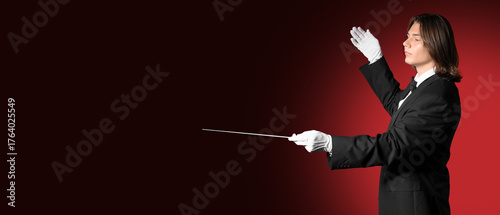 Male conductor on red backg...