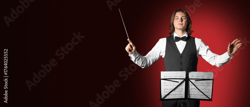 Male conductor with note sh...