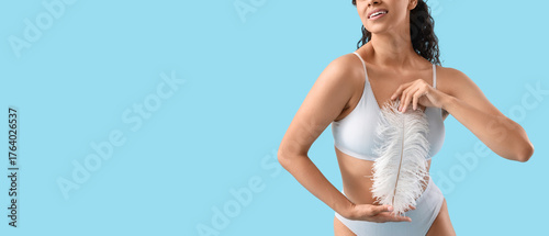 Young woman with feather on...