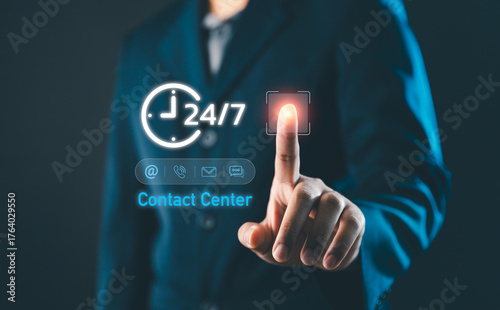 Businessman touching virtual contact center icon with 24 hours and 7 days support symbol, representing digital communication, customer service technology and modern online business solutions