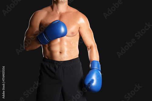Male boxer on black background