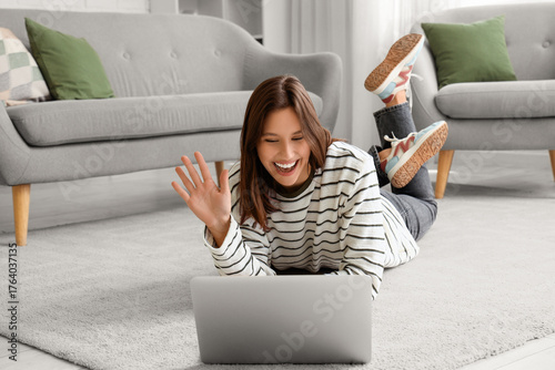 Happy young woman with lapt...