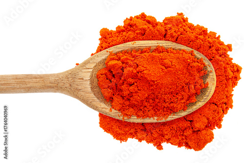 Close-up of food coloring powder in rustic wooden spoon on white background