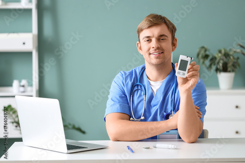 Male doctor with glucometer...