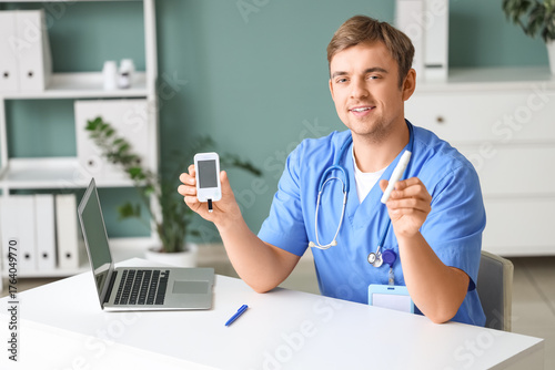 Male doctor with lancet pen...