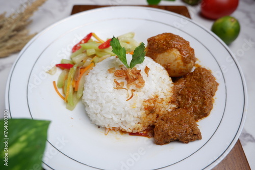 asi rames , catering box , food service ( rice, beef rendang, chicken, chili, vegetables). close up view. Nasi Uduk, Nasi Warteg