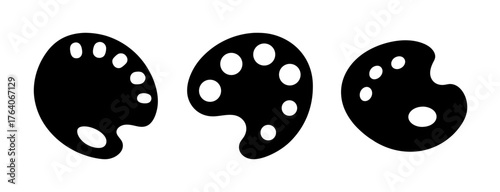 Three black artist paint palettes with circular depressions for colors creative art supplies